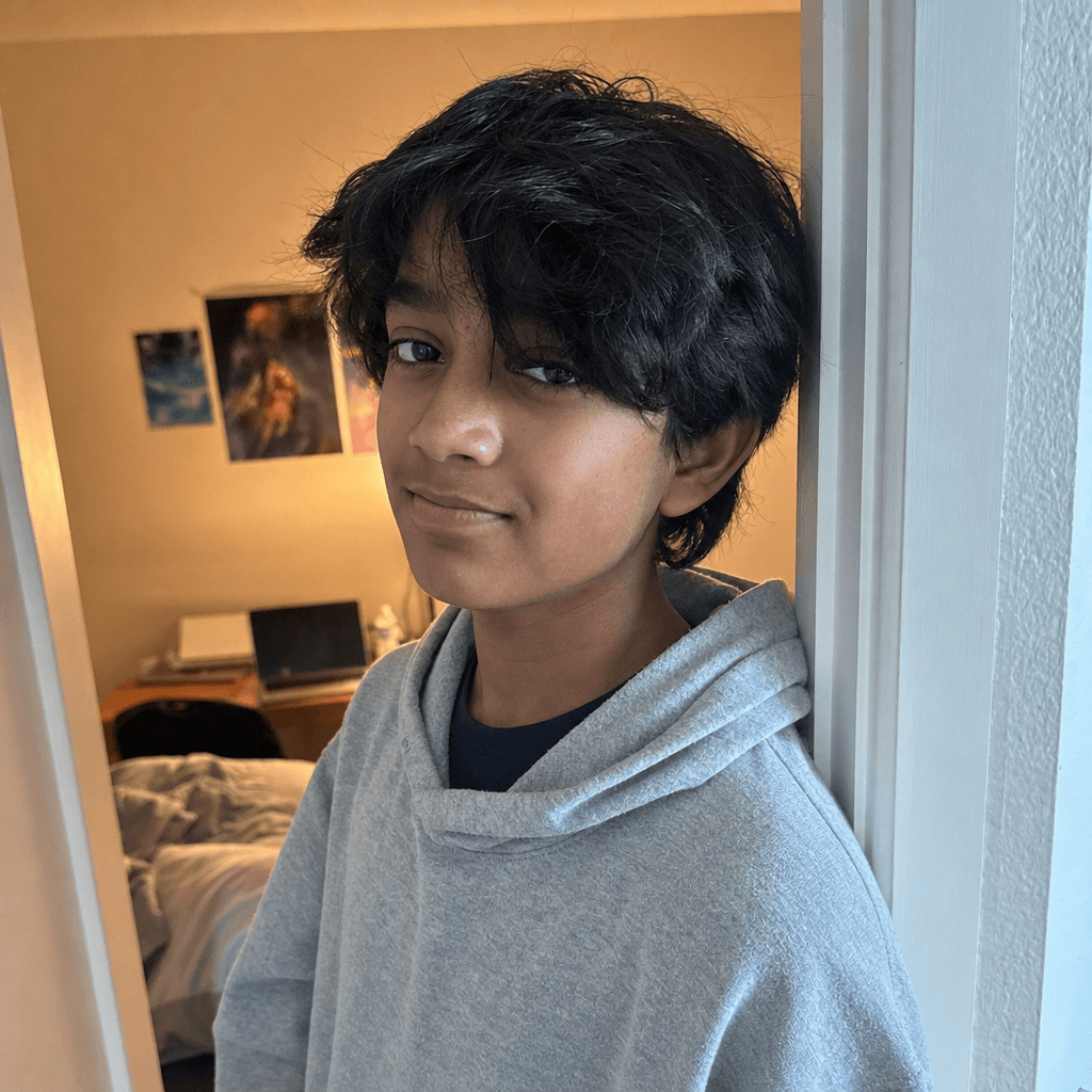 Arjun's source photo in a gray hoodie.